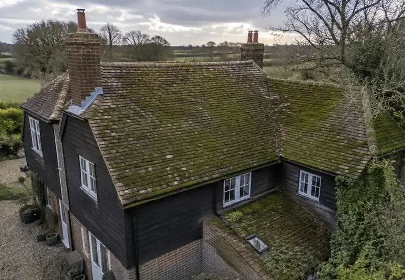 Before: Period farmhouse roof, fully cleaned, roof covered in moss